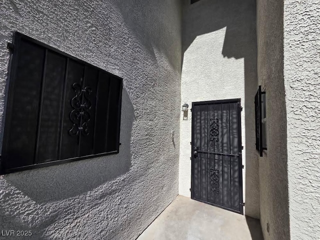 1739 N Lamont St, Las Vegas, NV 89115 - doorway to property featuring stucco siding