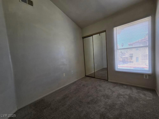 1739 N Lamont St, Las Vegas, NV 89115 - unfurnished bedroom featuring carpet flooring, vaulted ceiling, and a closet