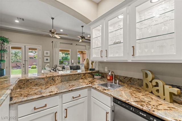 9747 Cathedral Pines Ave, Las Vegas, NV 89149 - kitchen featuring dishwasher, ceiling fan, white cabinets, recessed lighting, and light stone countertops