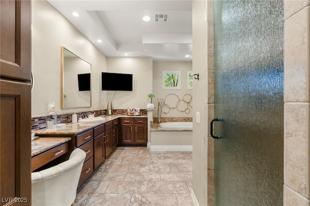 9747 Cathedral Pines Ave, Las Vegas, NV 89149 - bathroom with vanity, a bath, a stall shower, and recessed lighting