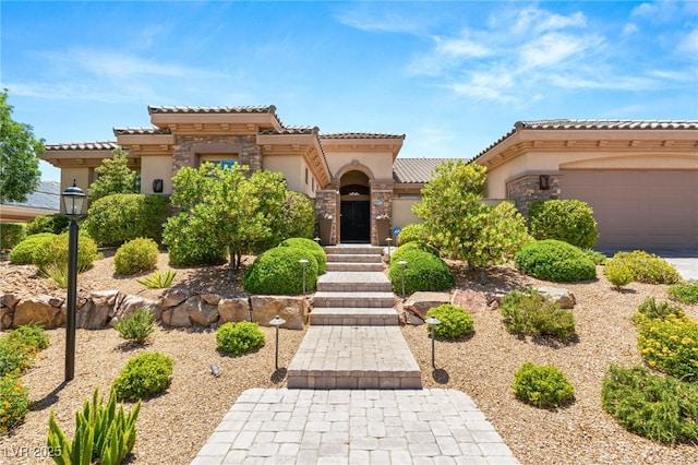 9747 Cathedral Pines Ave, Las Vegas, NV 89149 - mediterranean / spanish-style home with stucco siding, a tile roof, an attached garage, and stone siding