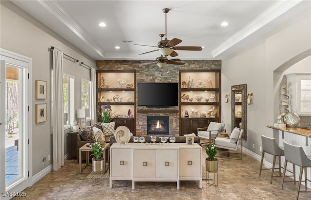 9747 Cathedral Pines Ave, Las Vegas, NV 89149 - living area with a ceiling fan, crown molding, a large fireplace, arched walkways, and recessed lighting