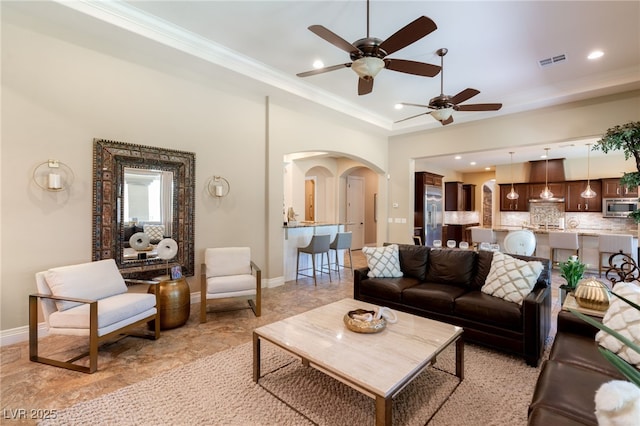 9747 Cathedral Pines Ave, Las Vegas, NV 89149 - living area with arched walkways, a ceiling fan, ornamental molding, a raised ceiling, and recessed lighting