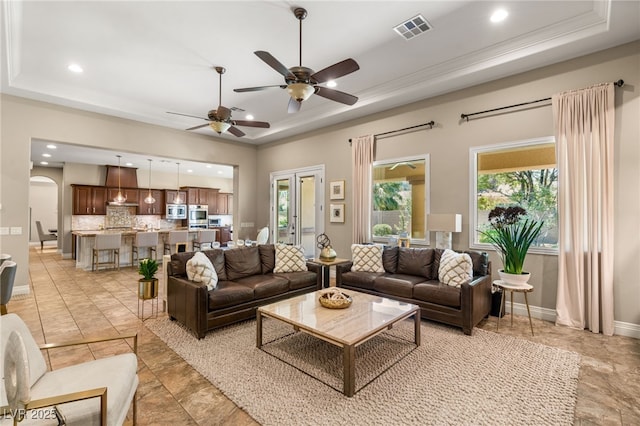9747 Cathedral Pines Ave, Las Vegas, NV 89149 - living area with a raised ceiling, recessed lighting, a ceiling fan, plenty of natural light, and ornamental molding
