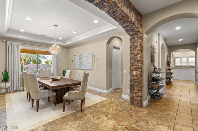 9747 Cathedral Pines Ave, Las Vegas, NV 89149 - dining room with a tray ceiling, arched walkways, a chandelier, recessed lighting, and ornamental molding