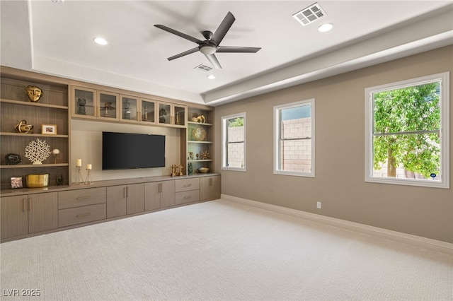 9747 Cathedral Pines Ave, Las Vegas, NV 89149 - unfurnished living room featuring carpet, healthy amount of natural light, recessed lighting, ceiling fan, and a raised ceiling