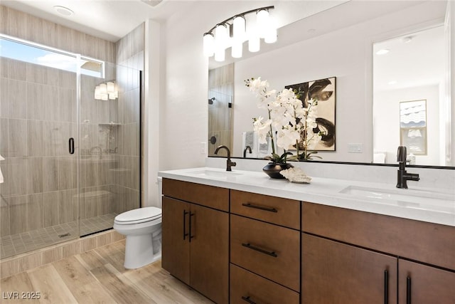11756 Emerald Lake Ave, Las Vegas, NV 89138 - full bathroom with double vanity, a stall shower, healthy amount of natural light, and wood finished floors