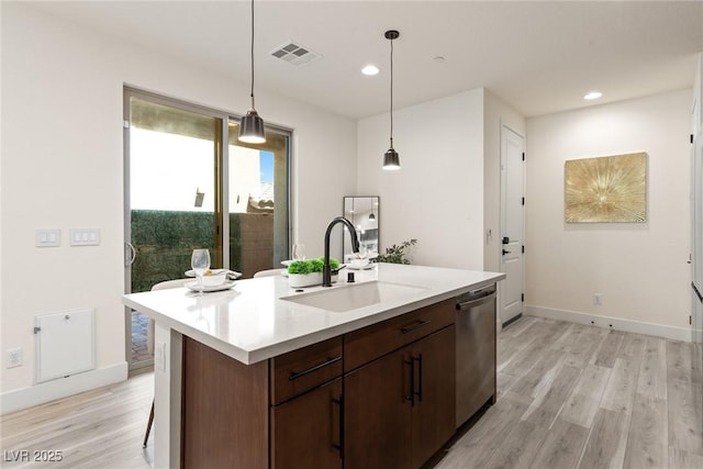 11756 Emerald Lake Ave, Las Vegas, NV 89138 - kitchen with stainless steel dishwasher, light wood-style floors, pendant lighting, light countertops, and recessed lighting