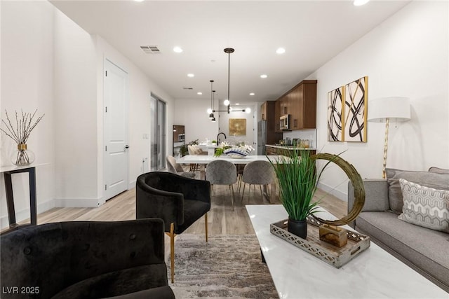 11756 Emerald Lake Ave, Las Vegas, NV 89138 - living room featuring light wood-type flooring and recessed lighting