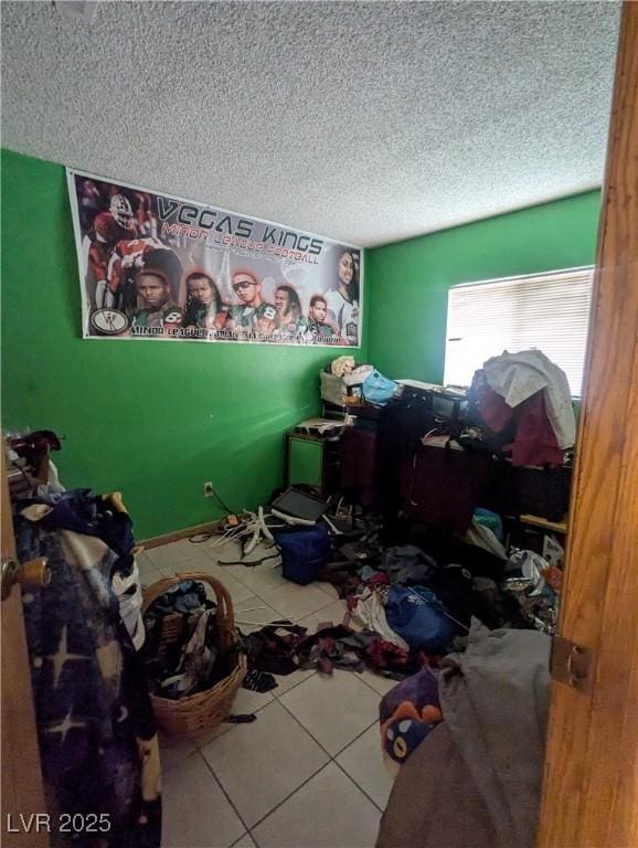4238 Rollingstone Dr, Las Vegas, NV 89103 - unfurnished bedroom with tile patterned floors and a textured ceiling