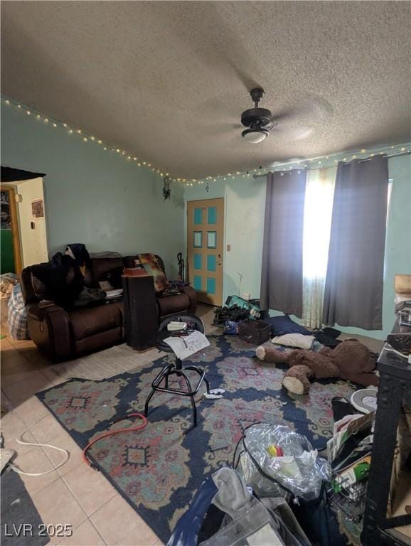 4238 Rollingstone Dr, Las Vegas, NV 89103 - tiled living room featuring ceiling fan and a textured ceiling