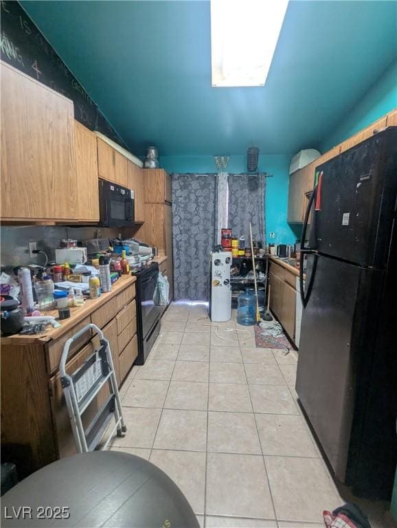 4238 Rollingstone Dr, Las Vegas, NV 89103 - kitchen with black appliances, light tile patterned flooring, and light countertops