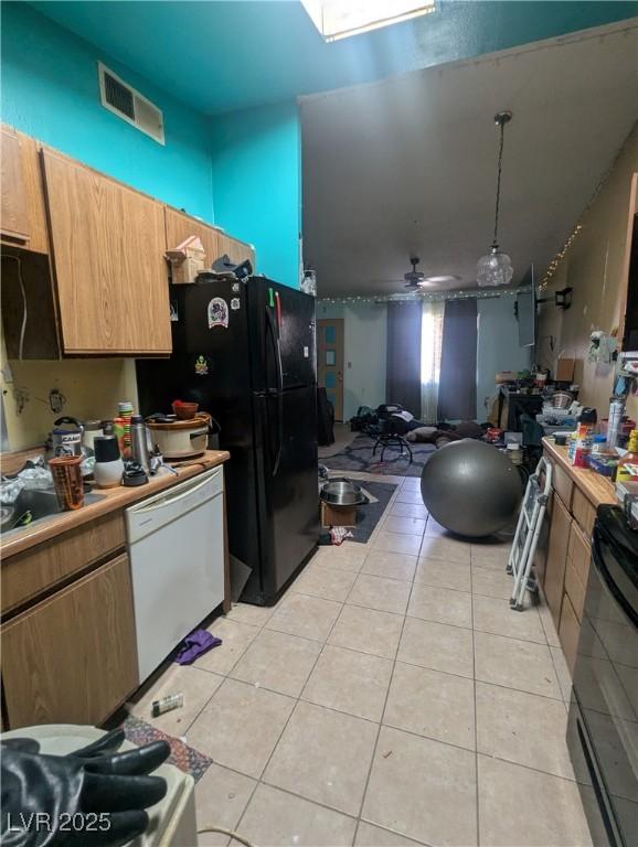 4238 Rollingstone Dr, Las Vegas, NV 89103 - kitchen featuring white dishwasher, light tile patterned floors, stove, a ceiling fan, and light countertops