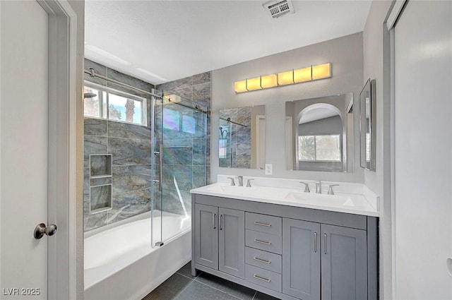 901 Carnival Ave, Las Vegas, NV 89123 - bathroom featuring bath / shower combo with glass door, double vanity, and tile patterned flooring