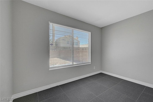 901 Carnival Ave, Las Vegas, NV 89123 - empty room featuring plenty of natural light and dark tile patterned flooring