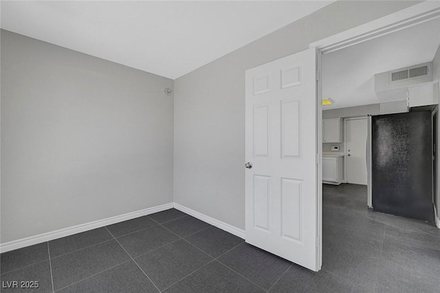 901 Carnival Ave, Las Vegas, NV 89123 - spare room with baseboards and dark tile patterned flooring