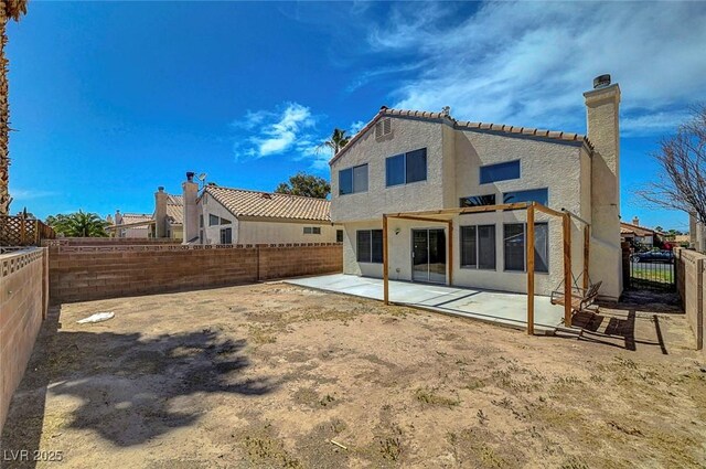 901 Carnival Ave, Las Vegas, NV 89123 - rear view of property with stucco siding, a chimney, a fenced backyard, a patio area, and a tiled roof