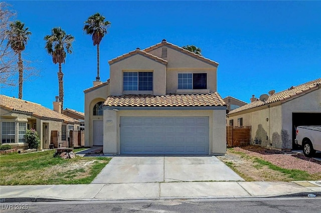 901 Carnival Ave, Las Vegas, NV 89123 - mediterranean / spanish home with a tiled roof, stucco siding, driveway, and an attached garage