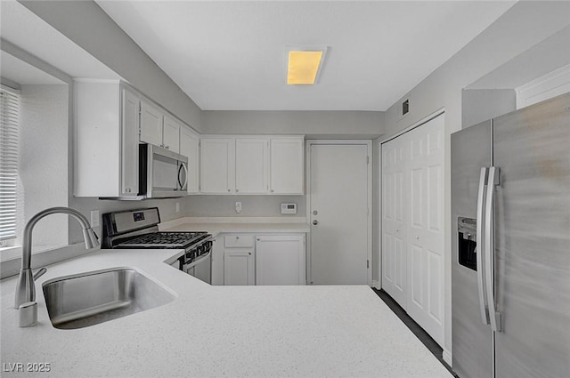 901 Carnival Ave, Las Vegas, NV 89123 - kitchen with stainless steel appliances, light countertops, and white cabinets