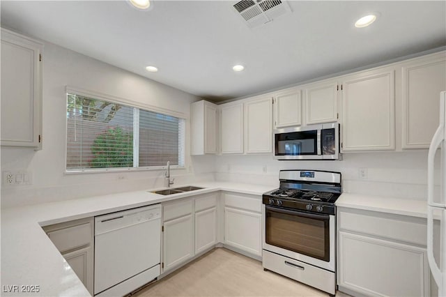 2431 Lilac Cove St, Las Vegas, NV 89135 - kitchen with appliances with stainless steel finishes, recessed lighting, light countertops, and white cabinets