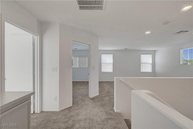 2431 Lilac Cove St, Las Vegas, NV 89135 - hallway featuring light colored carpet, recessed lighting, and an upstairs landing
