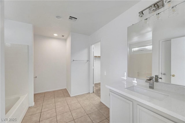 2431 Lilac Cove St, Las Vegas, NV 89135 - bathroom featuring vanity, a bathtub, tile patterned flooring, a walk in closet, and recessed lighting
