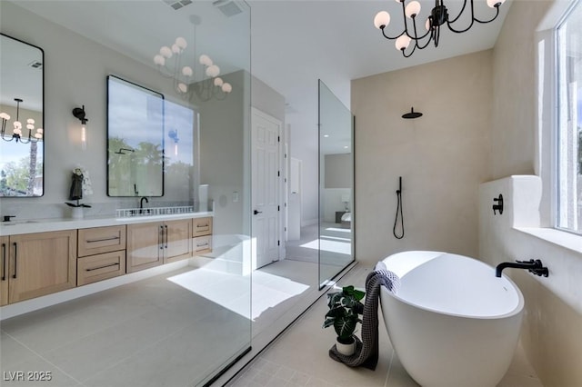 5573 San Florentine Ave, Las Vegas, NV 89141 - bathroom with a chandelier, a freestanding tub, and double vanity