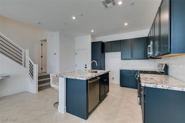 9844 Kings Glen St, Las Vegas, NV 89141 - kitchen featuring stainless steel appliances, light stone countertops, recessed lighting, backsplash, and a center island with sink