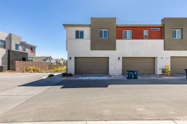 9844 Kings Glen St, Las Vegas, NV 89141 - back of property with an attached garage and stucco siding