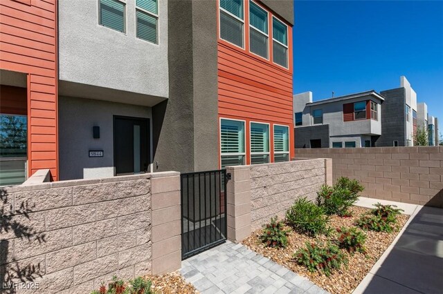 9844 Kings Glen St, Las Vegas, NV 89141 - view of exterior entry featuring a gate and stucco siding