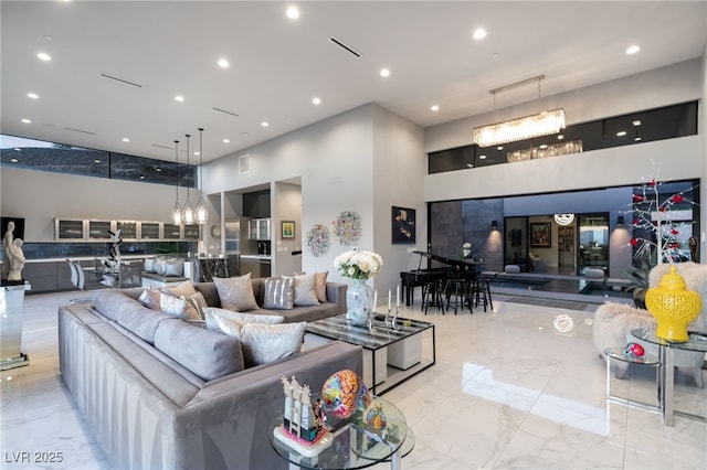671 Scenic Rim Dr, Henderson, NV 89012 - living area featuring a high ceiling, marble tiled floors, a chandelier, and recessed lighting