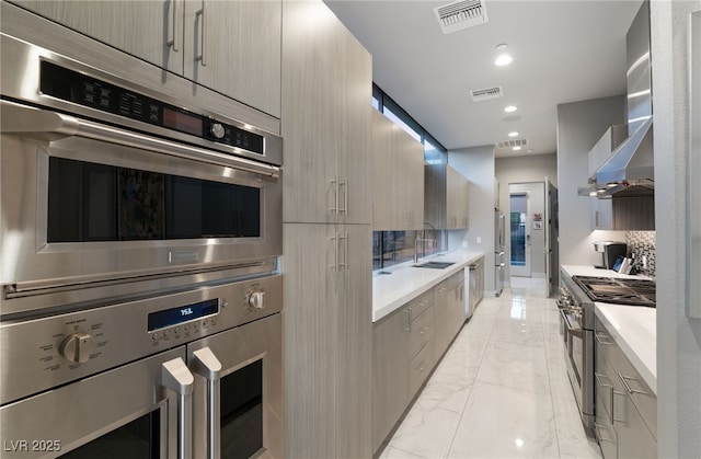 671 Scenic Rim Dr, Henderson, NV 89012 - kitchen featuring appliances with stainless steel finishes, modern cabinets, light marble finish flooring, light countertops, and recessed lighting