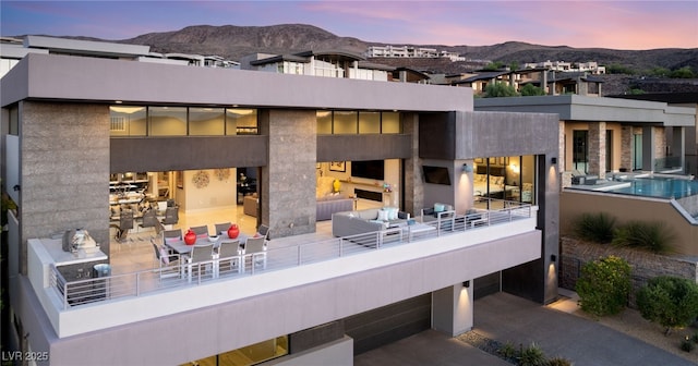 671 Scenic Rim Dr, Henderson, NV 89012 - back of house at dusk with outdoor lounge area