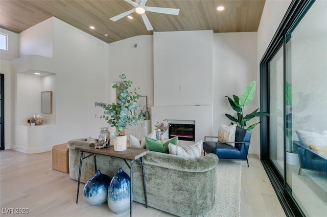 9425 Villa Ridge Dr, Las Vegas, NV 89134 - living area featuring a glass covered fireplace, wood finished floors, ceiling fan, recessed lighting, and wooden ceiling