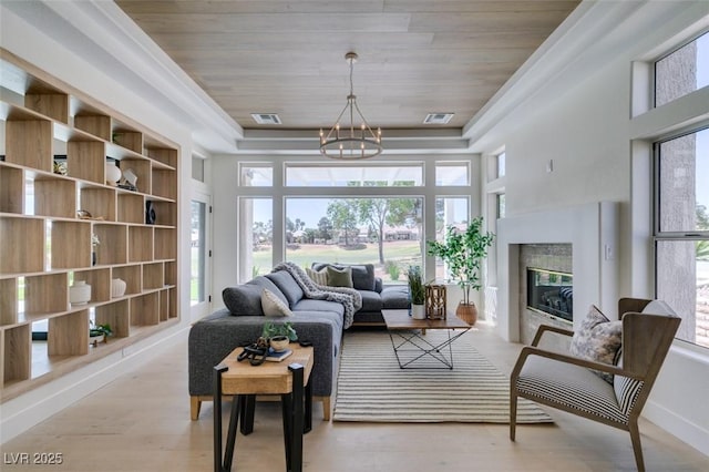 9425 Villa Ridge Dr, Las Vegas, NV 89134 - living room with a tray ceiling, a chandelier, wood ceiling, wood finished floors, and a high end fireplace