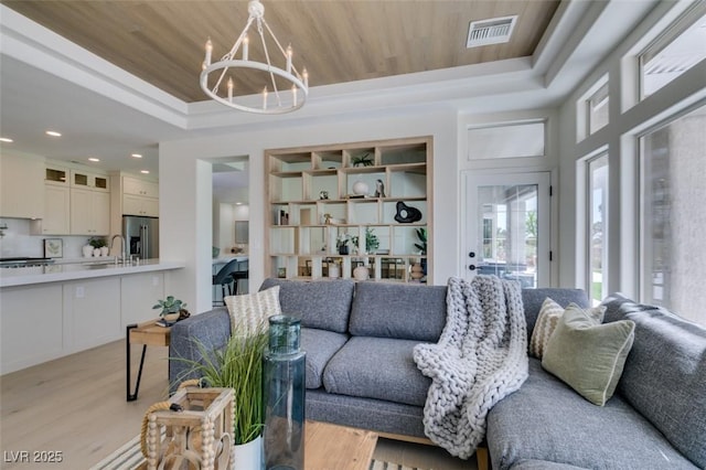 9425 Villa Ridge Dr, Las Vegas, NV 89134 - living room with a tray ceiling, a chandelier, light wood finished floors, and recessed lighting