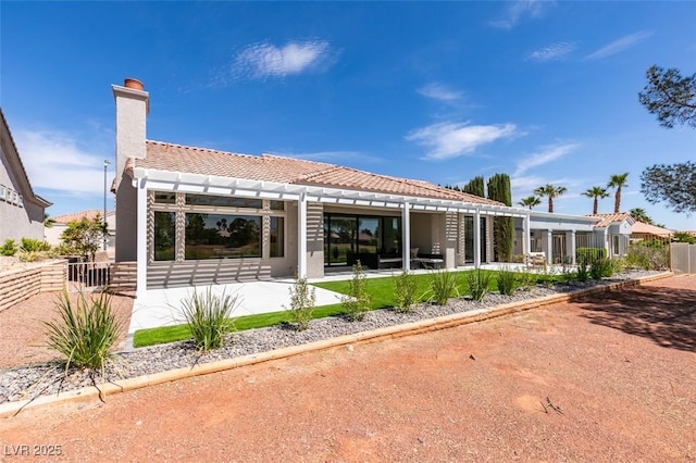 9425 Villa Ridge Dr, Las Vegas, NV 89134 - rear view of house featuring a tiled roof, stucco siding, a chimney, and a patio