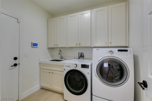 9425 Villa Ridge Dr, Las Vegas, NV 89134 - laundry area featuring cabinet space, washer and clothes dryer, and light wood-type flooring