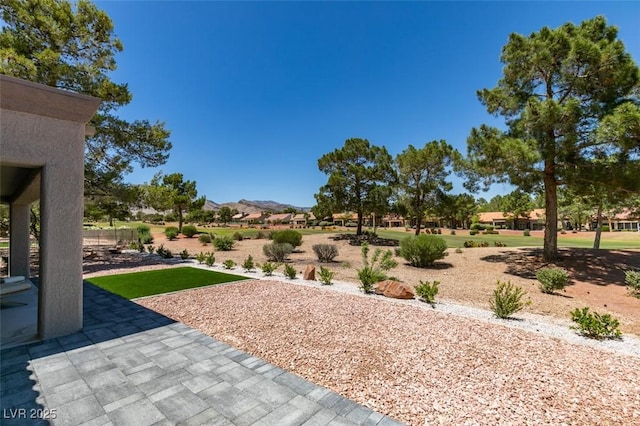 9520 Sundial Dr, Las Vegas, NV 89134 - view of yard with a mountain view and a patio area