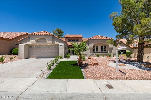 9520 Sundial Dr, Las Vegas, NV 89134 - mediterranean / spanish-style house with stucco siding, a garage, a tiled roof, and driveway