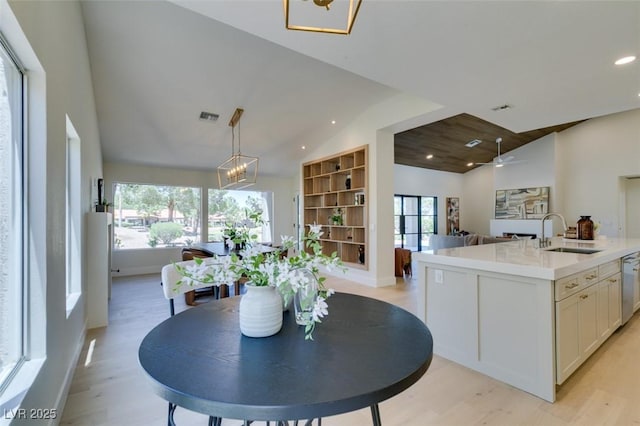 9520 Sundial Dr, Las Vegas, NV 89134 - kitchen featuring open floor plan, light wood-type flooring, white cabinets, recessed lighting, and light countertops