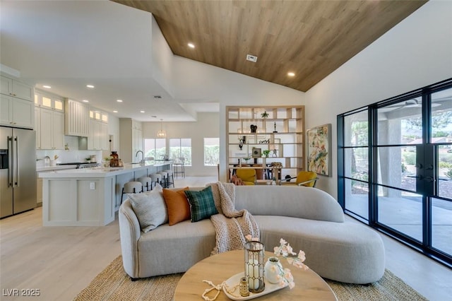 9520 Sundial Dr, Las Vegas, NV 89134 - living room with recessed lighting, high vaulted ceiling, light wood-type flooring, wood ceiling, and french doors
