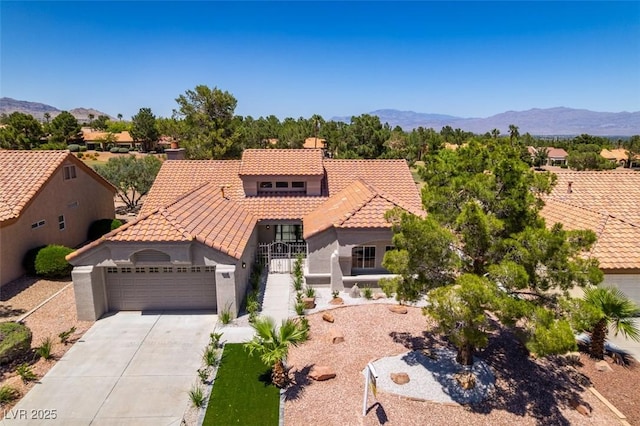 9520 Sundial Dr, Las Vegas, NV 89134 - mediterranean / spanish-style house with a tile roof, a garage, driveway, stucco siding, and a mountain view