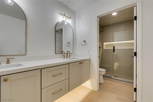 9520 Sundial Dr, Las Vegas, NV 89134 - bathroom featuring a stall shower, wood finished floors, and double vanity