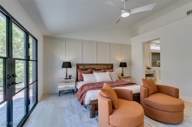 9520 Sundial Dr, Las Vegas, NV 89134 - bedroom with multiple windows, vaulted ceiling, access to exterior, a ceiling fan, and a decorative wall