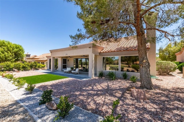 9520 Sundial Dr, Las Vegas, NV 89134 - back of house with a ceiling fan, stucco siding, a tile roof, and a patio