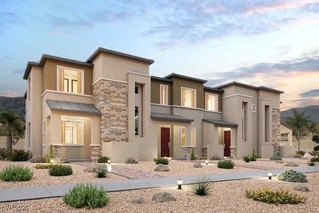 197 Wewatta Ave, Henderson, NV 89011 - view of front of house with a standing seam roof, stone siding, stucco siding, and a metal roof