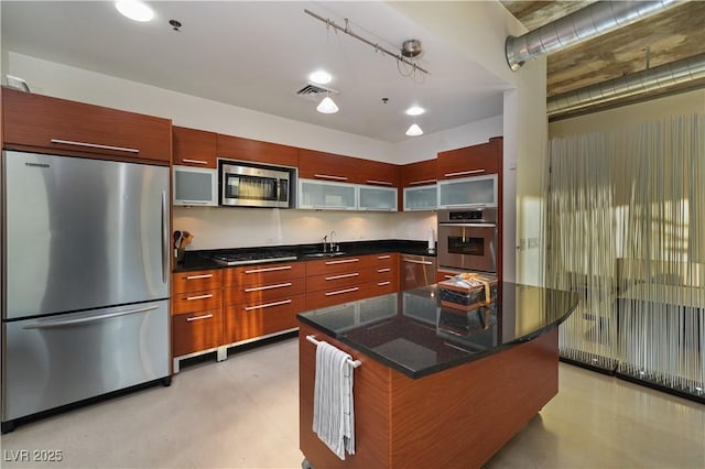 900 Las Vegas Blvd Unit 912, Las Vegas, NV 89101 - kitchen with stainless steel appliances, modern cabinets, glass insert cabinets, finished concrete floors, and rail lighting