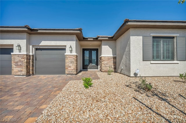 5851 Slate Rock Ct, Las Vegas, NV 89149 - view of front of home with french doors, stone siding, stucco siding, and an attached garage