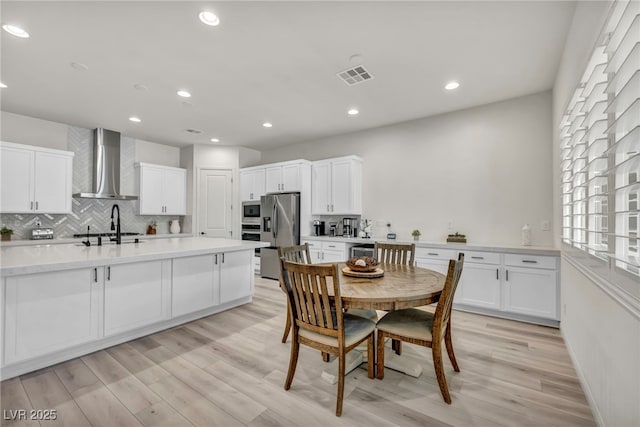 5851 Slate Rock Ct, Las Vegas, NV 89149 - dining area featuring light wood-style flooring, recessed lighting, and beverage cooler